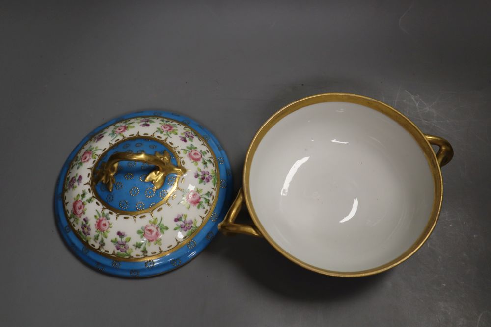 A 19th century Paris porcelain handled bowl and cover painted with roses under turquoise borders, width 19cm height 12cm